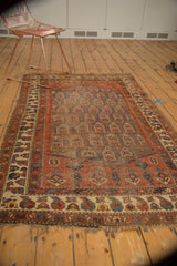 Antique Northwest Persian rug displaying unique floral boteh patterns with asymmetry and rich patina.