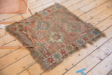 Fragmented corner of an antique Caucasian rug showing foundation, tatter, and worn fringe.