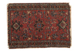 Antique Lilihan rug with a cherry red field, ornate trefoil medallion, and blue-green floral patterns.