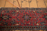 Classic Persian Lilihan rug border with geometric motifs, rich red field, and tattered fringe.