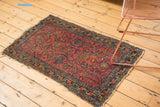 Vintage Lilihan rug featuring raspberry field, allover floral pattern, and tattered ends.