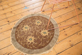 Antique Peking rug's worn bronze field, faded gold florals, and ocean green accents.