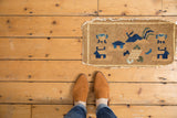 Antique Peking pictorial rug mat featuring vases, huts, mountain range, and tattered edges.
