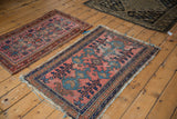 Antique Lilihan rug with dusty blush field, sky blue accents, showing wear and tattered ends.