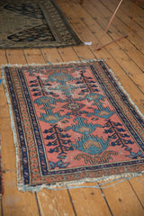 Antique Lilihan rug's upper corner with tattered edge, exposed foundation, and navy floral borders.