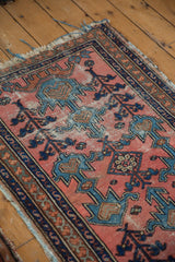 Antique Persian Lilihan rug detail: dusty blush field, blue plant motifs, and visible foundation wear.
