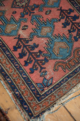 Antique Lilihan rug corner, meandering vine border, exposed foundation, tattered fringe.