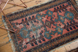 Antique Lilihan rug featuring oversized plant designs, serpent motif borders, and visible wear.
