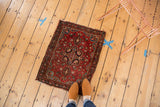 Vintage Farahan Sarouk rug with intricate cherry red floral field and navy outlining.