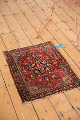 Vintage Farahan Sarouk rug upper corner, cherry red field, and detailed floral border.