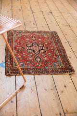 Tattered end and lightly tattered, secure side of the vintage Farahan Sarouk rug.