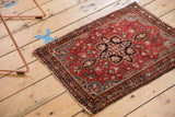 Vintage Farahan Sarouk rug corner, cherry red field with intricate floral borders, light side tatter.