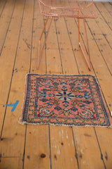 Antique Lilihan rug corner, highlighting intricate floral border and tattered edge.