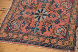 Corner detail of antique Lilihan rug, showcasing intricate floral border and aged pile.