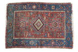 Antique Karaja rug: gem-like cherry red field, sky blue borders, geometric medallion design.