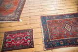 Antique Heriz area Karaja rug with geometric medallion, cherry red, and sky blue borders.