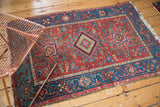 Antique Karaja rug with cherry red field, geometric motifs, and sky blue border.
