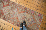 Distressed Oushak runner's central pile showing stepped serrated contours and faded colors.