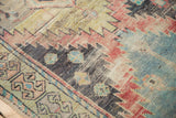 Distressed Oushak runner's textural weave, geometric motifs in sky blue, saffron, aubergine.