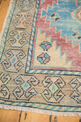 Vintage distressed Oushak rug runner border in sky blue, celadon, and dusty saffron tones.