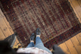 Antique Belouch rug featuring unusual vertical channels of water and blossomed flowers in deep reds and blues.