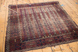 Hard tatter and threadbare pile on Antique Belouch rug, with unique channel and flower motifs.