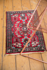 Vintage Hamadan rug corner, displaying its dark border, ivory fringe, and Lilihan-like floral motifs.