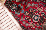 Lilihan-like floral design with cherry red, sky blue, and blush on vintage Hamadan rug.