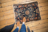 Dark indigo and blush oversized floral design, with visible wear and tattered fringe.