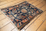 Antique Persian Lilihan rug detail: tattered fringe, blush rose border, worn indigo floral field.