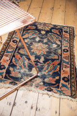 Antique Persian Lilihan rug corner with hard tattered fringe and blush rose floral design.