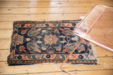 Antique Lilihan mat with a dark indigo field, featuring oversized blush rose and ivory floral designs.