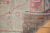 Vintage distressed Oushak rug detail showing faded geometric pile, fringe, and hand-knotted back.