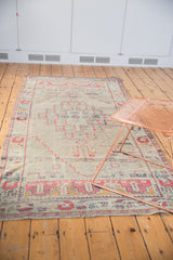 Distressed Oushak rug runner, showing faded pile texture, geometric border, and short fringe.