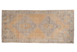 Vintage distressed Oushak runner: soft saffron field, double diamond slate blue medallions, 3'8