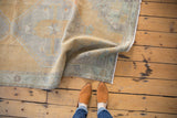 Close-up of vintage Oushak runner showing soft saffron yellow, slate blue geometric patterns, and fine even wear.