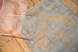 Distressed vintage Oushak runner; faded saffron, slate blue, and mint green tones reveal storied texture.