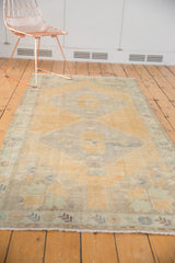 Distressed Oushak runner's corner spandrel with pale saffron yellow, mint green border, even wear.