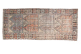 Vintage distressed Oushak runner with faded red blush, slate blue, and ivory multi-panel design.