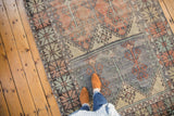 Distressed Oushak runner's multi-panel design with slate blue, faded blush, and tree motifs.