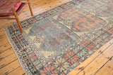 Distressed Oushak runner featuring faded blue and red tree-of-life multi-panel motifs.