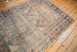 Distressed vintage Oushak runner with faded red, blue, and ivory serrated leaf border.