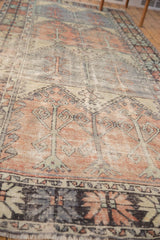 Distressed Oushak runner border with slate blue, faded red blush, and worn 'tree of life' motifs.