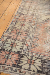 Vintage Distressed Oushak runner's faded red, mint, and blue floral panel with visible foundation wear.