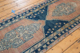 Blush and blue serrated medallion detail on the distressed vintage Oushak runner.