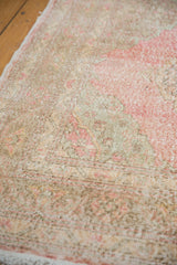 Distressed Sparta rug texture with even wear, faded pinks, neutral ivory, and visible foundation.