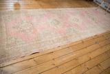 Distressed vintage Turkish Sparta runner with even wear, pink, ivory, and bronze tones.