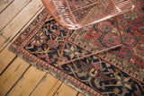 Vintage Heriz carpet corner showing Laleh Abassi border, polychrome selvage, and fringed wear.