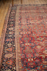 Vintage Heriz rug with dark blue floral main border and Laleh Abassi minor border.