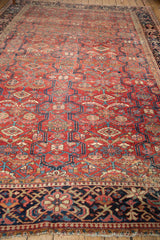Oversized floral border, Laleh Abassi motifs, and secured fringe on a vintage Heriz rug.